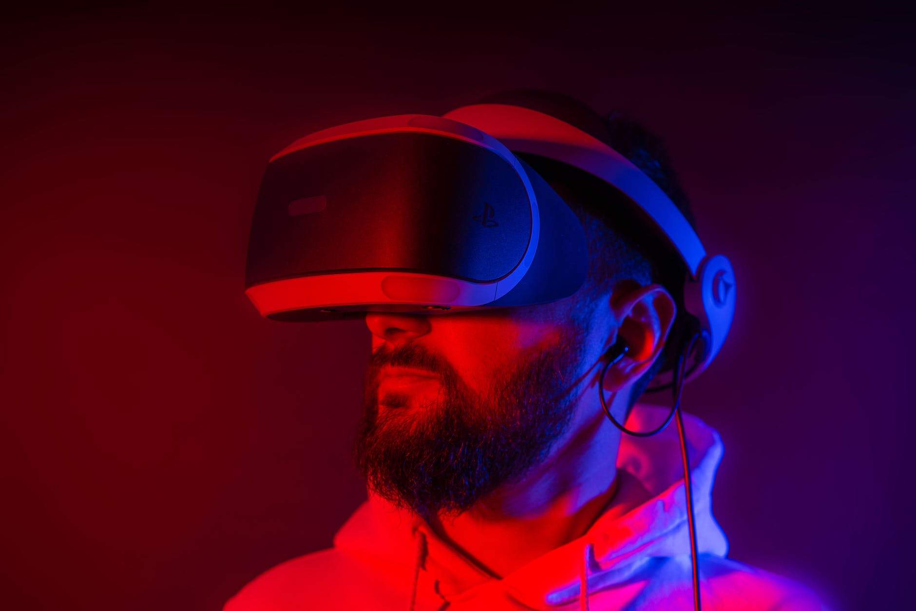 bearded man using virtual reality glasses